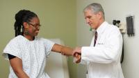 A rheumatologist at ColumbiaDoctors examining a patient with inflammatory arthritis